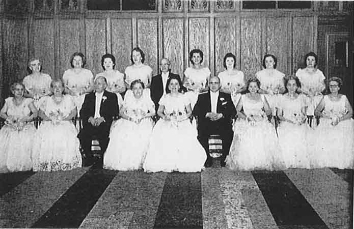 A group of people in white posing for a photo.