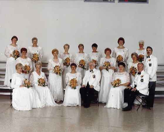 A group of people in white dresses posing for a photo.