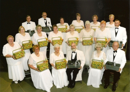 A group of people in white tuxedos posing with baskets.