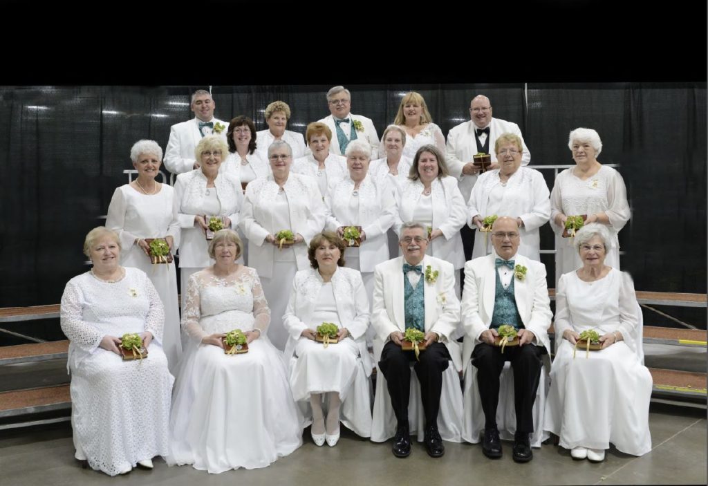 A group of people dressed in white posing for a photo.