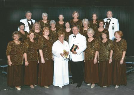 A group of people in formal attire posing for a photo.
