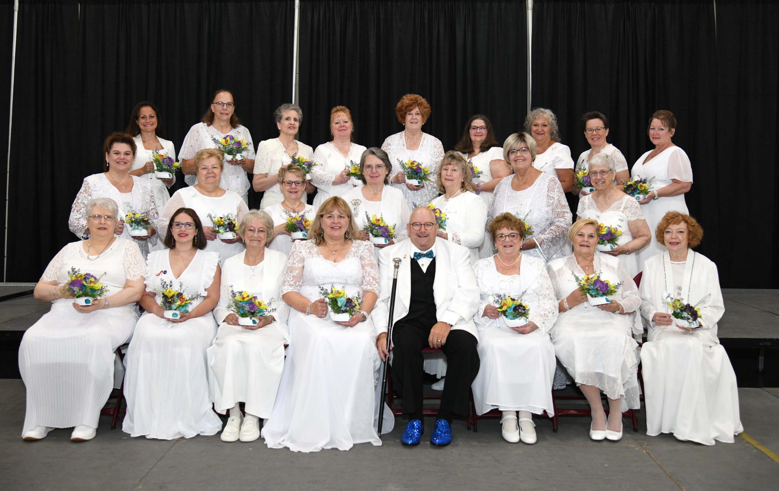 A group in white posing for a photo.