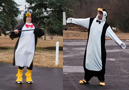 Two people dressed up as penguins.
