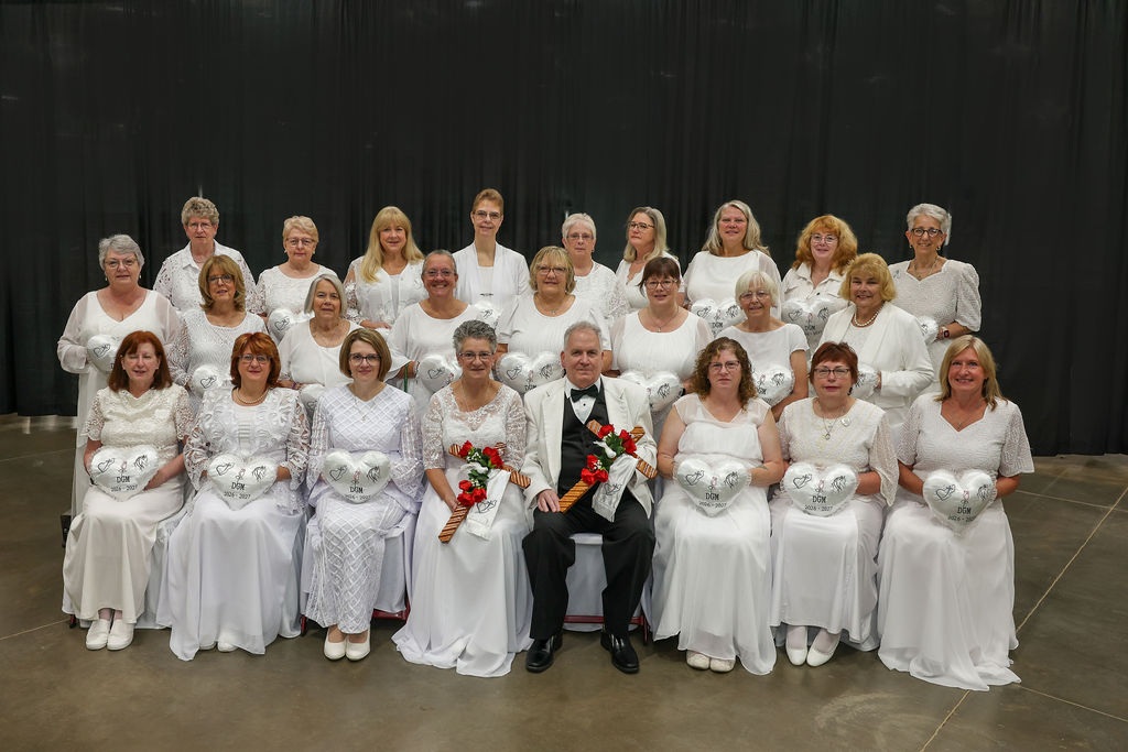 OES(709of13) DGM 2026-2027 Group of seated women dressed in white surrounding the Grand Matron and Grand Patron.