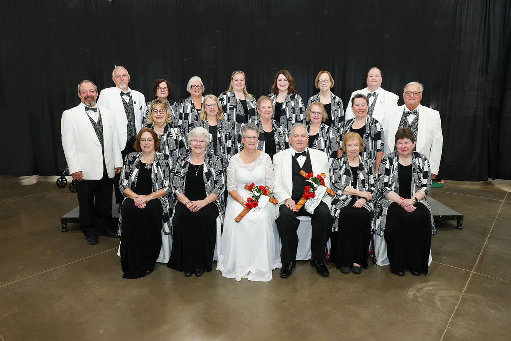 Group of men and women dressed in black and white.